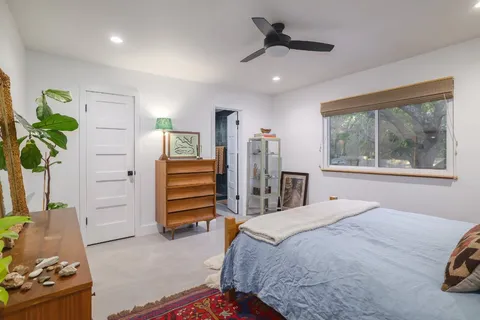 a bedroom with a bed and a window