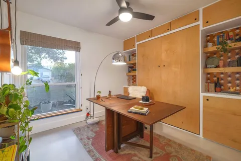 a workspace with furniture and window