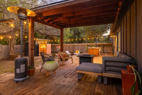 a living room with patio furniture and a fireplace