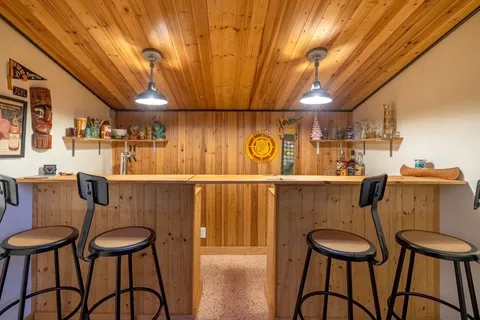 a view of a dining room with furniture and chandelier