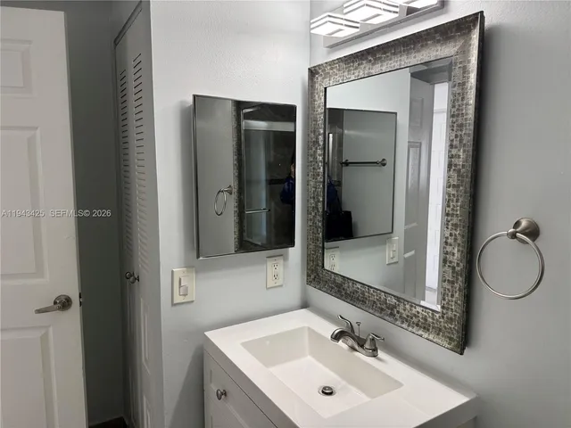 a bathroom with a sink and mirror