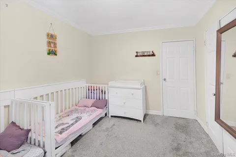 a view of a bedroom with baby crib