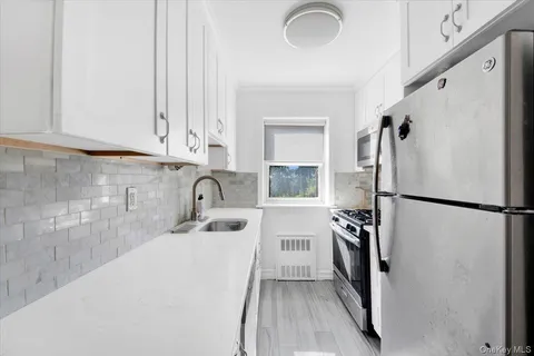 a kitchen with a refrigerator a sink and cabinets