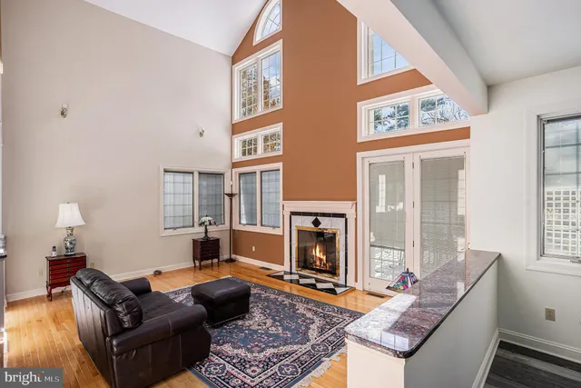a kitchen that has a table chairs in it and wooden floors