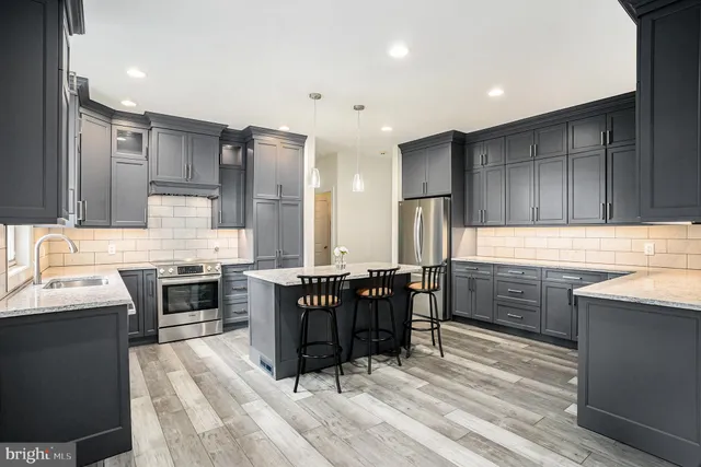 a kitchen with a stove a sink and a refrigerator