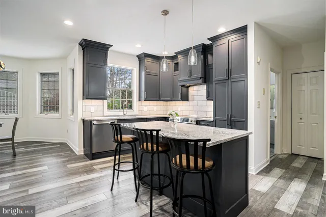 a kitchen with a refrigerator a sink and cabinets