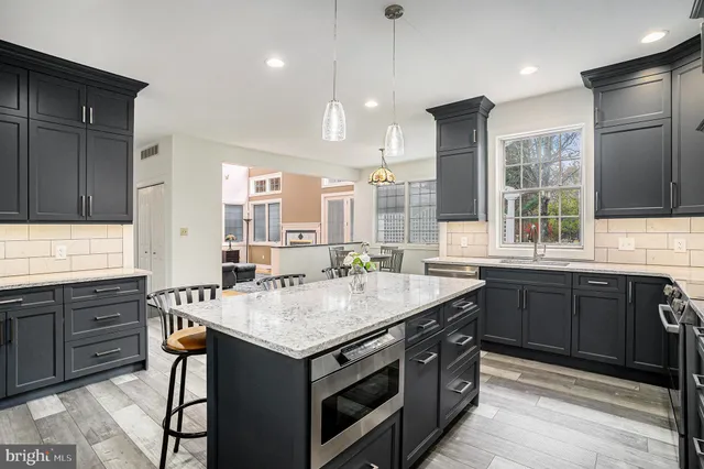 a kitchen with a sink stove and cabinets