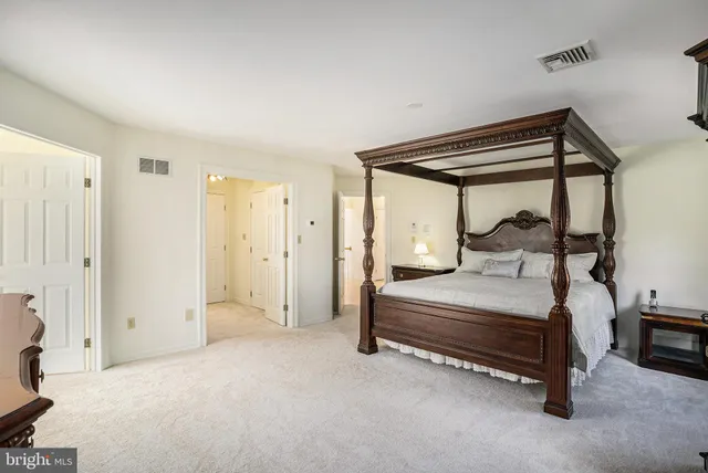 a spacious bathroom with a tub sink and mirror