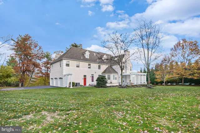 a front view of a house with a yard and a garage