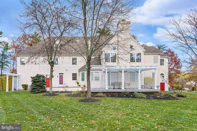 a view of a white house with a yard and plants