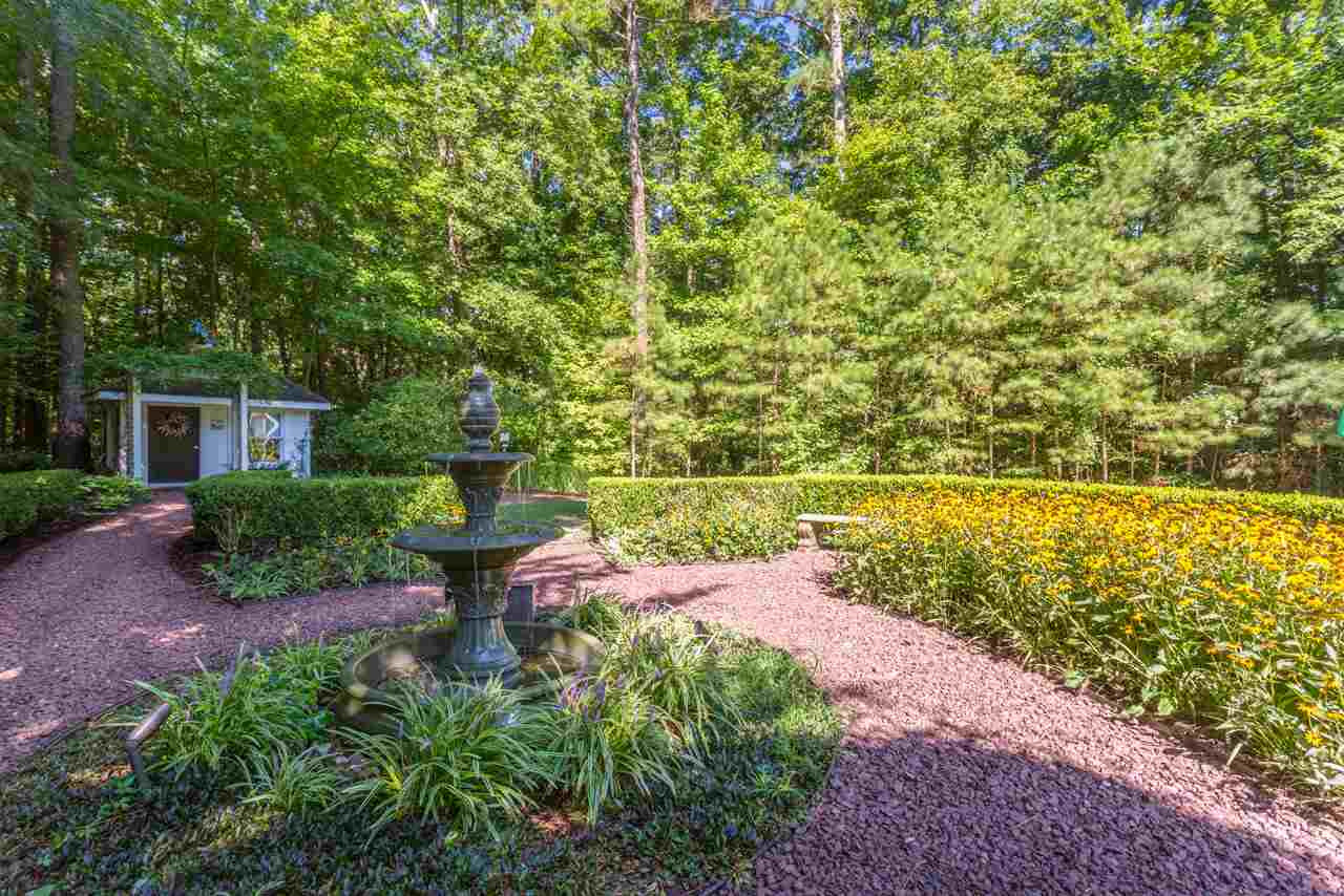 4921 Cremshaw Court Raleigh, NC 27614 - Photo 22 of 25 Crushed stone pathways lead through jasmine covered archways to the English Fountain Garden. This peaceful garden paradise features a beautiful three-tiered fountain and perennial gardens. A charming playhouse(or potting shed) is just beyond the garden. The English Fountain Garden
