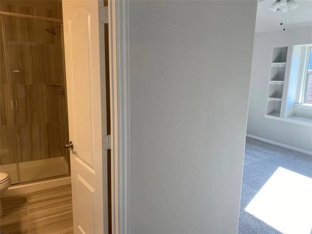 a view of a bathroom from a hallway