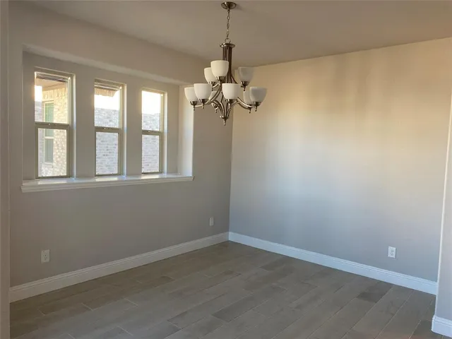 a view of a room that has a window and a chandelier