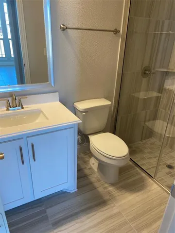 a bathroom with a toilet a sink a bath tub and a mirror