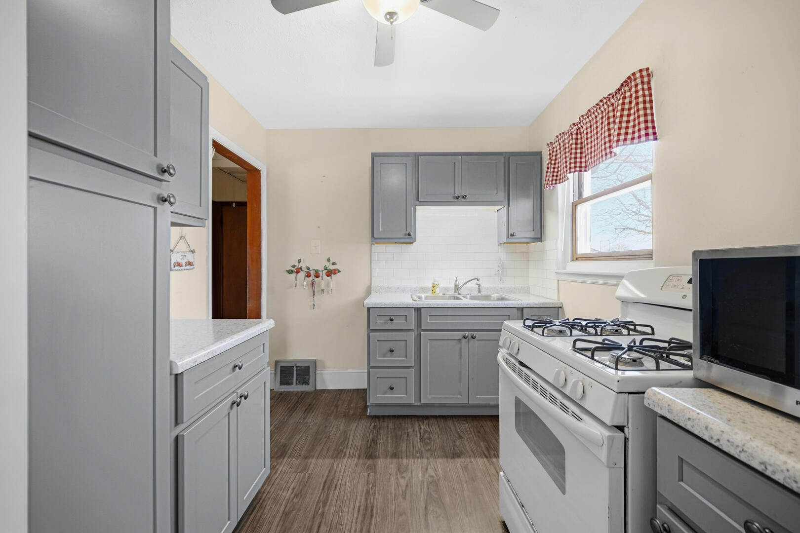 5405 Birch Avenue Hammond, IN 46320 - Photo 5 of 20 a kitchen with granite countertop cabinets a sink a window and stainless steel appliances