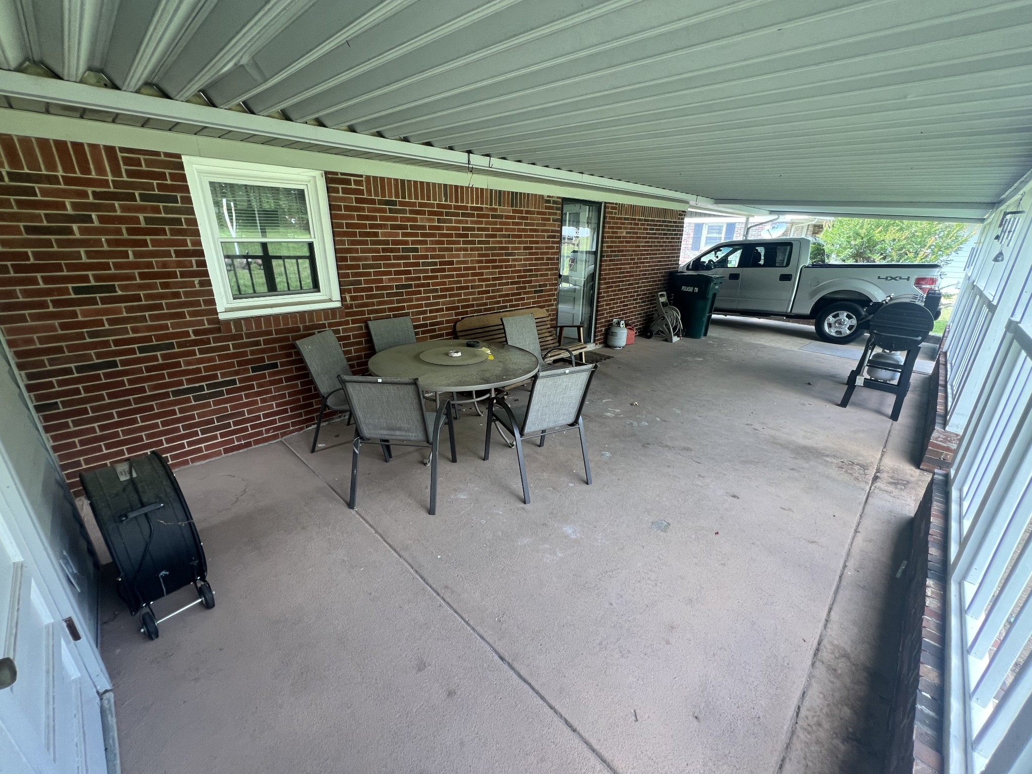 105 Tollgate Road Pulaski, TN 38478 - Photo 30 of 38 a view of a patio with table and chairs and potted plants
