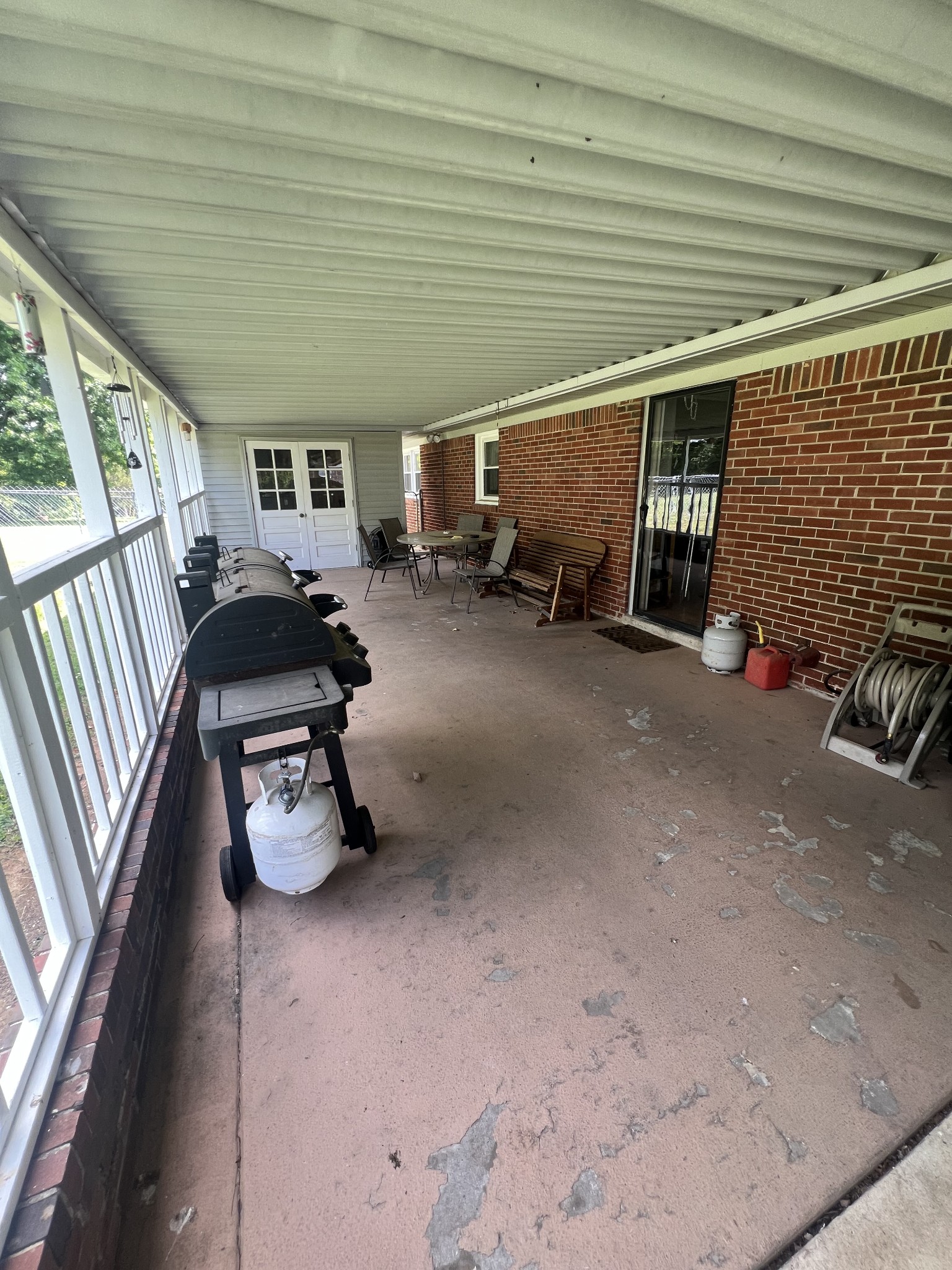 105 Tollgate Road Pulaski, TN 38478 - Photo 31 of 38 a view of a patio with table and chairs and a barbeque