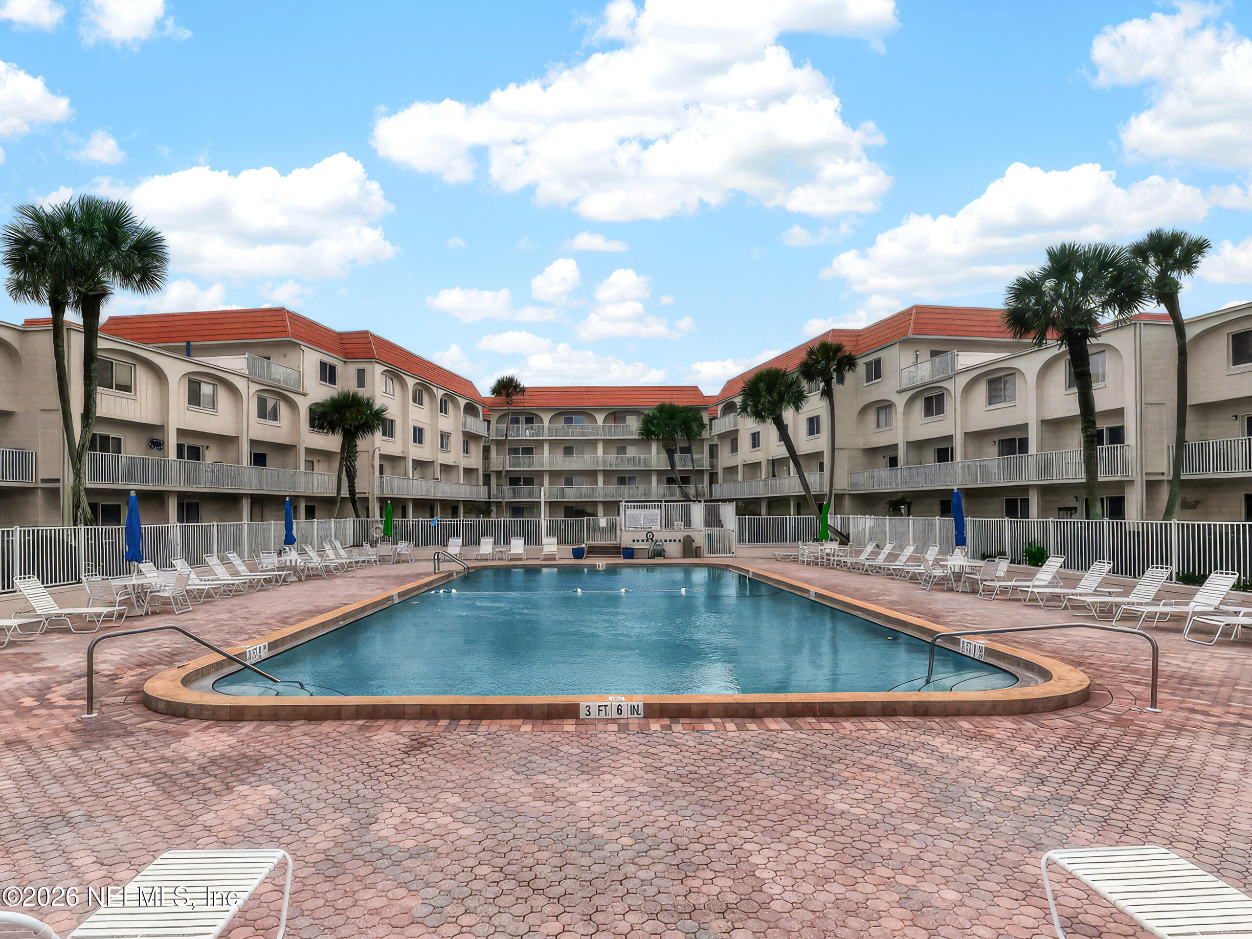 1 Ocean Trace Road, Unit 230 St. Augustine Beach, FL 32080 - Photo 37 of 50 a view of a building with a swimming pool