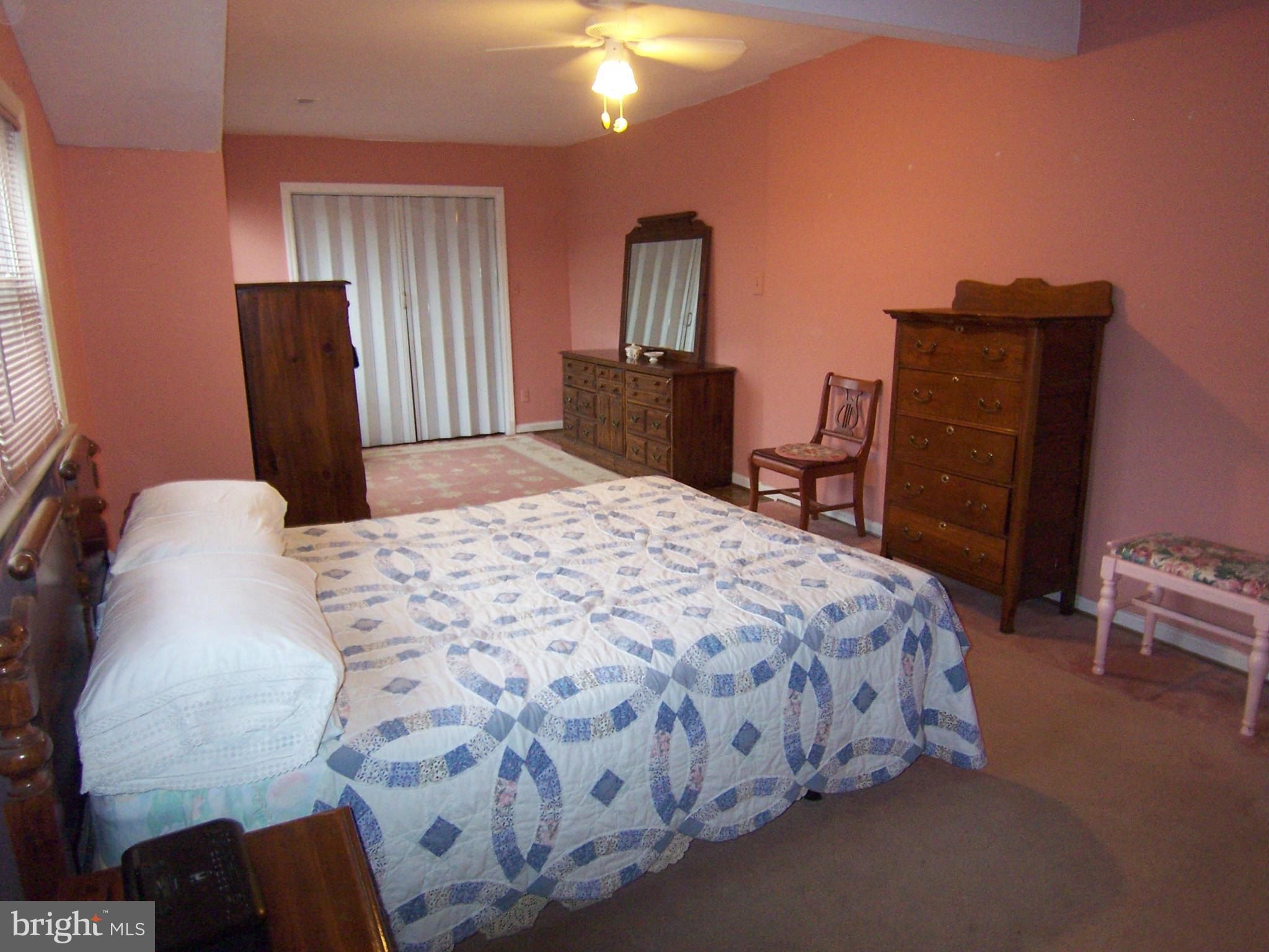 5322 Wakefield Road Bethesda, MD 20816 - Photo 11 of 14 a bedroom with a bed and a chandelier