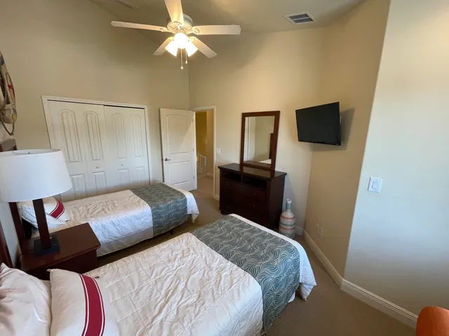 a bedroom with a bed and a television