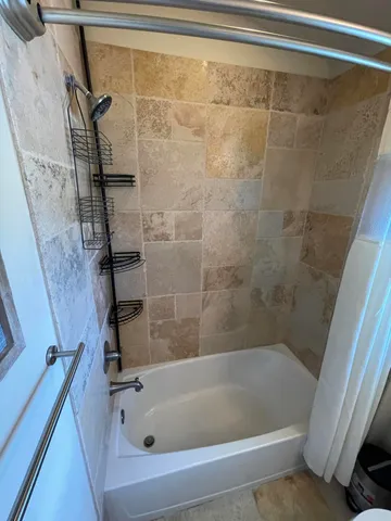 a bathroom with a shower and a bathtub