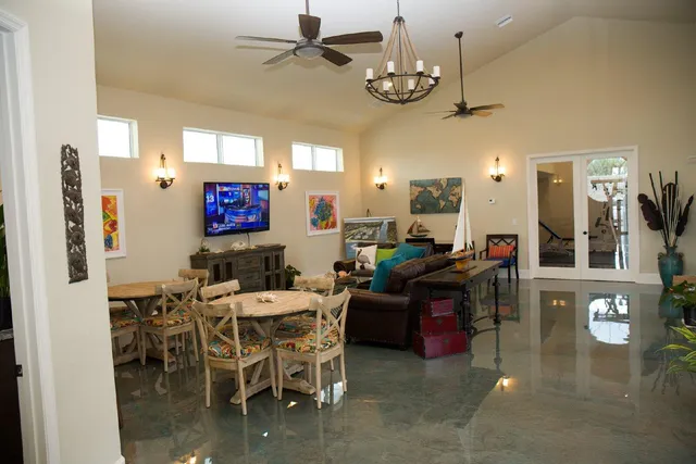 a living room with lots of furniture and chandelier
