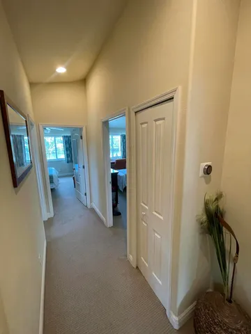 a view of a hallway with wooden shelves
