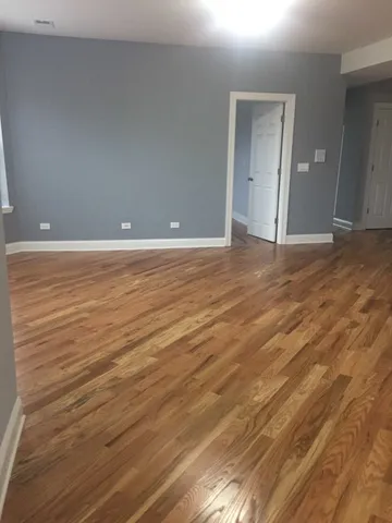 a view of a room with wooden floor