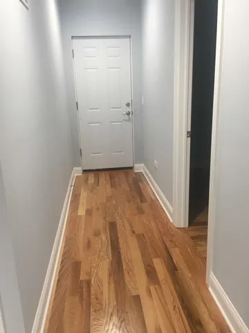 a view of a room with wooden floor