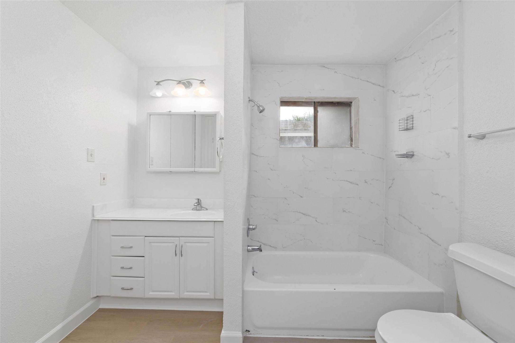 5023 Monteith Drive Spring, TX 77373 - Photo 13 of 20 Bright bathroom with a spacious vanity and large mirror, paired with a window in the shower area that brings in natural light for a fresh, airy feel.