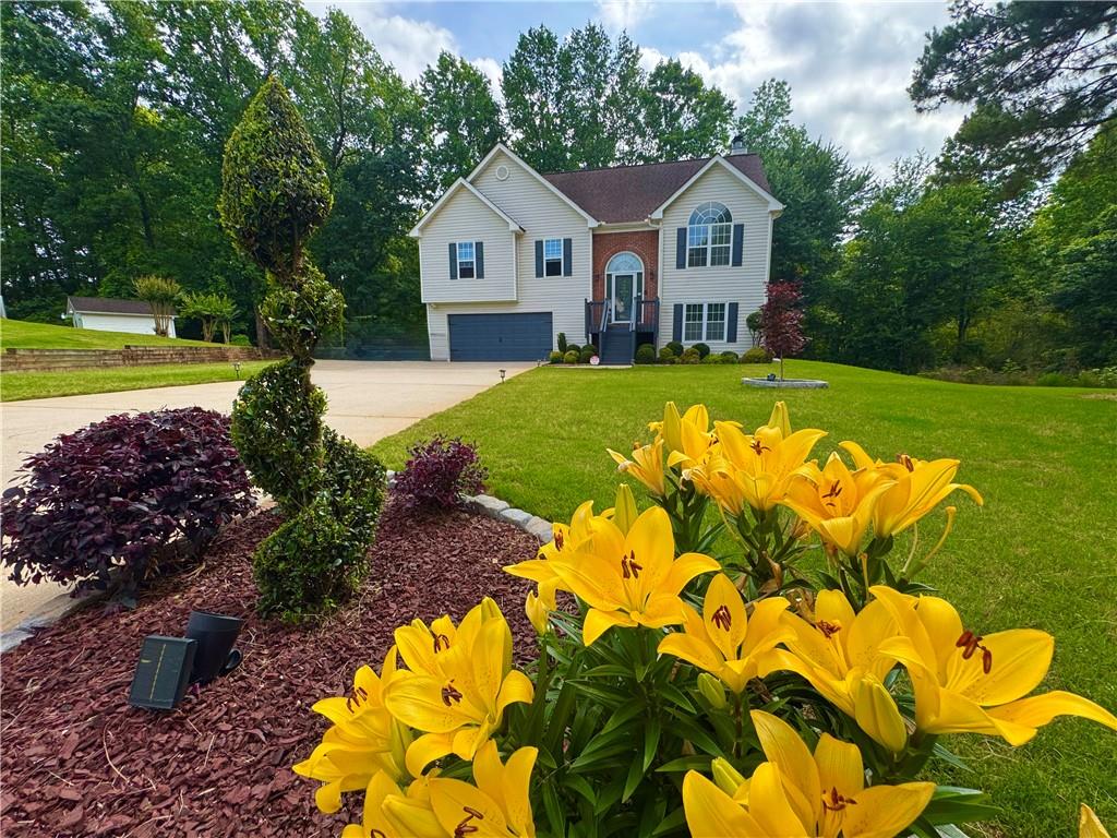 a view of a house with a big yard and large trees