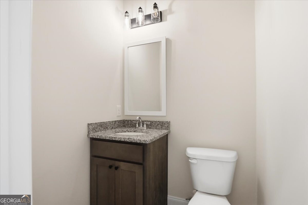 49 Wright Street, Unit 65 Lavonia, GA 30553 - Photo 16 of 57 a bathroom with a toilet sink and mirror