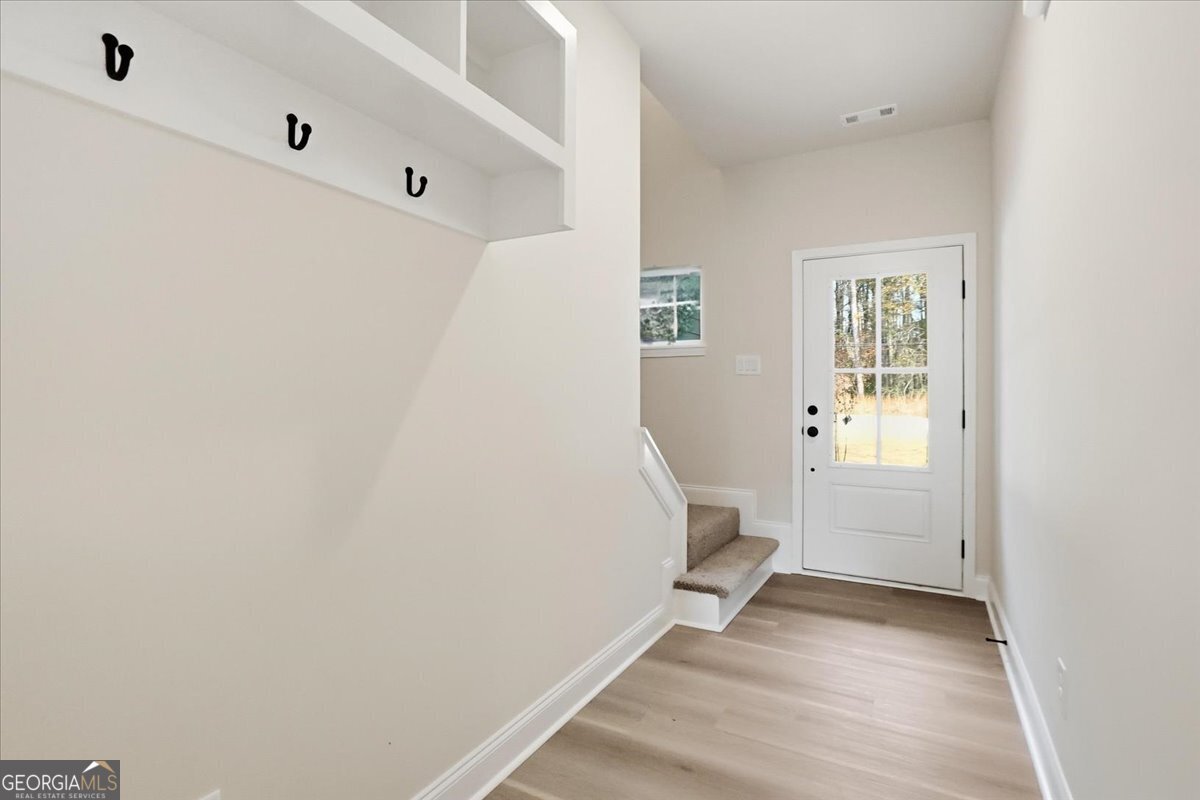 49 Wright Street, Unit 65 Lavonia, GA 30553 - Photo 17 of 57 a view of an empty room with wooden floor and a window