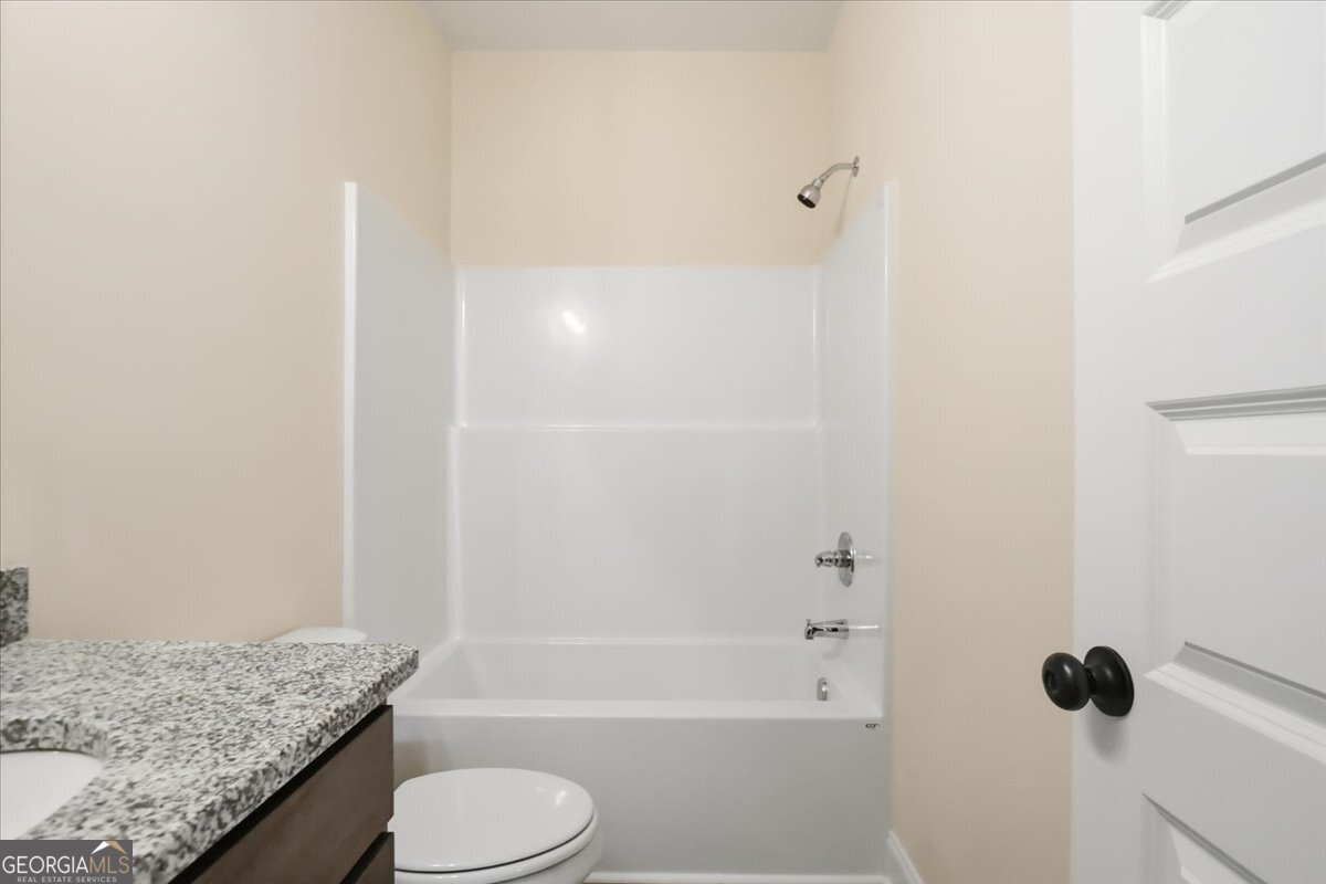 49 Wright Street, Unit 65 Lavonia, GA 30553 - Photo 25 of 57 a bathroom with a granite countertop sink toilet and shower