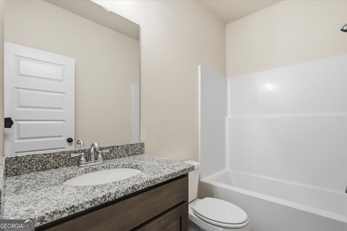 49 Wright Street, Unit 65 Lavonia, GA 30553 - Photo 26 of 57 a bathroom with a granite countertop sink toilet and shower