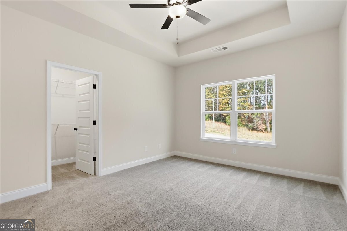 49 Wright Street, Unit 65 Lavonia, GA 30553 - Photo 29 of 57 an empty room with a ceiling fan and window