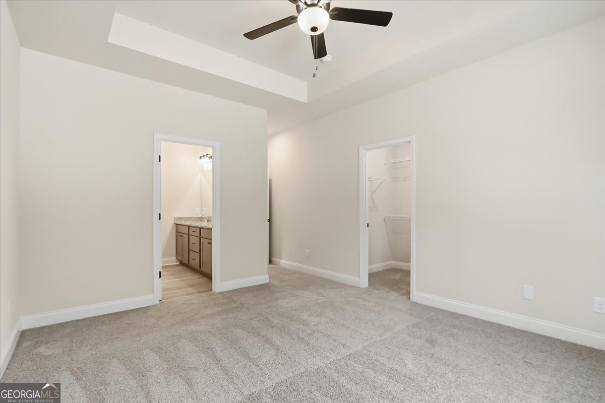 49 Wright Street, Unit 65 Lavonia, GA 30553 - Photo 30 of 57 an empty room with a ceiling fan and carpet