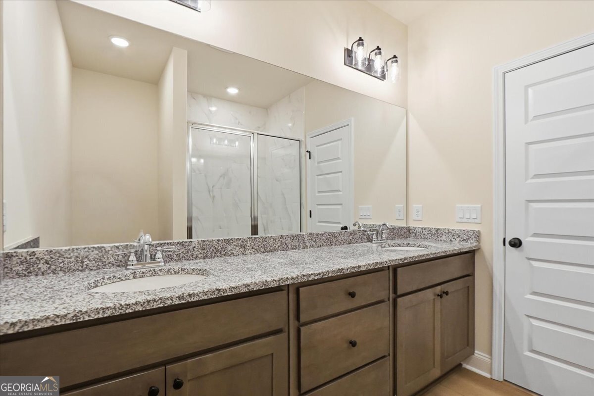 49 Wright Street, Unit 65 Lavonia, GA 30553 - Photo 33 of 57 a bathroom with a granite countertop sink double and mirror