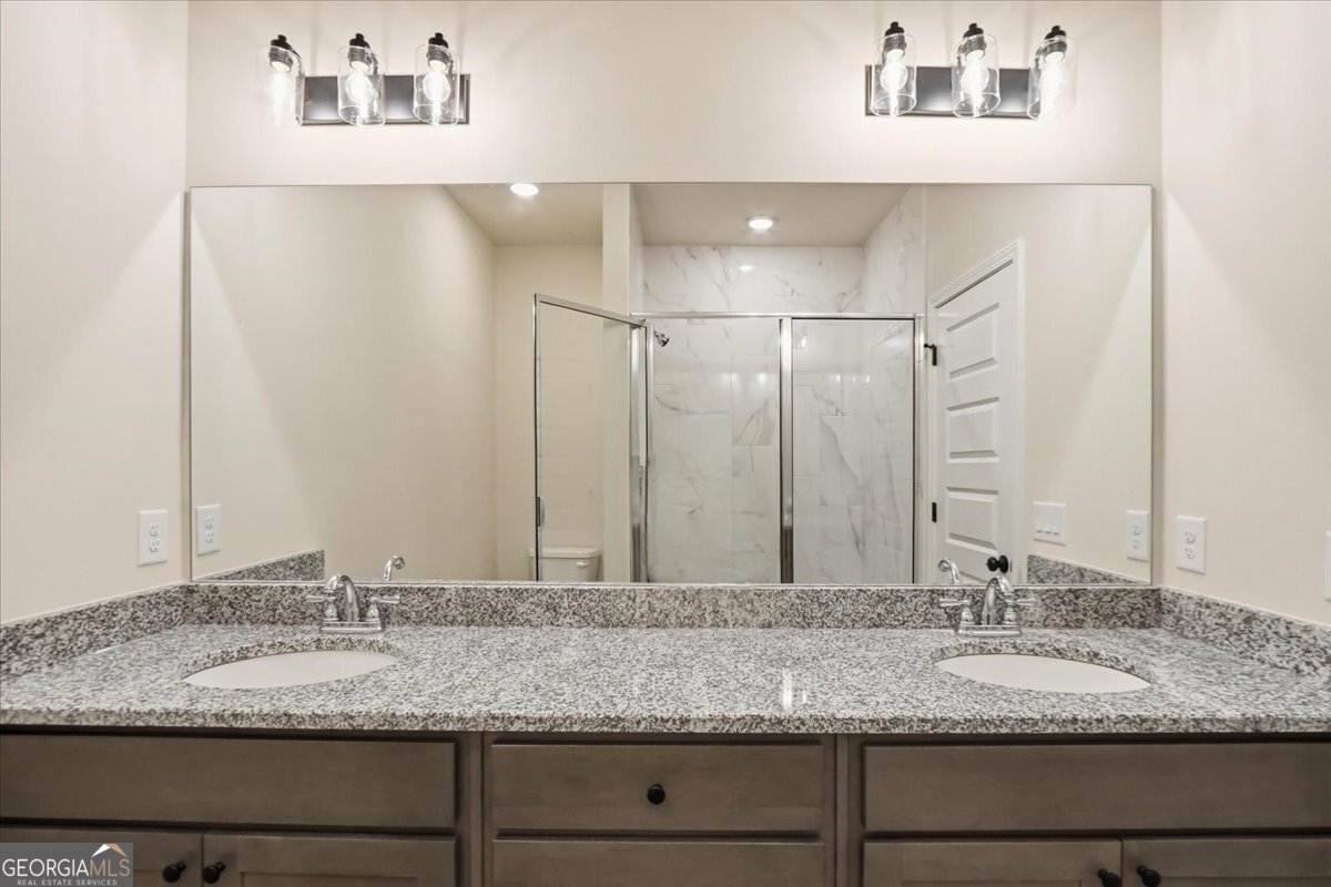 49 Wright Street, Unit 65 Lavonia, GA 30553 - Photo 34 of 57 a bathroom with a granite countertop sink and a mirror