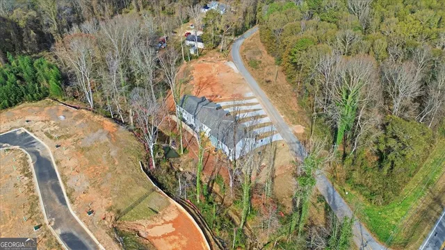 a view of a house with a large space and a large tree