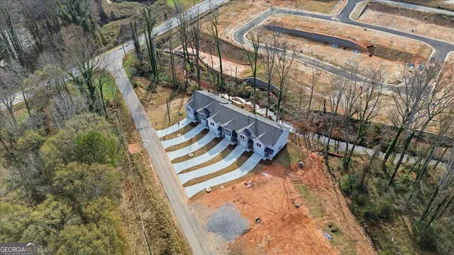 an aerial view of a house with a yard