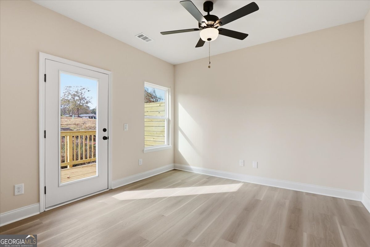 49 Wright Street, Unit 65 Lavonia, GA 30553 - Photo 6 of 57 wooden floor in an empty room with a window