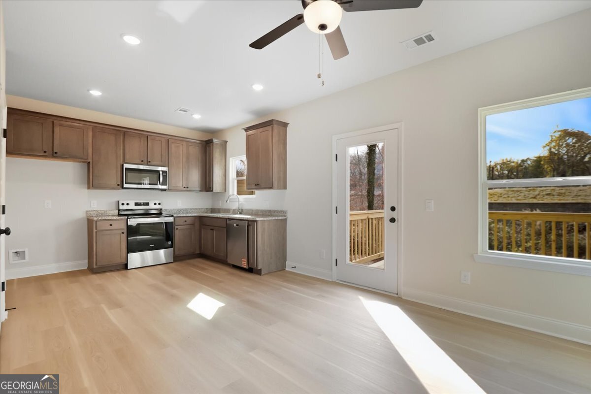 49 Wright Street, Unit 65 Lavonia, GA 30553 - Photo 9 of 57 a kitchen with stainless steel appliances a refrigerator sink and cabinets