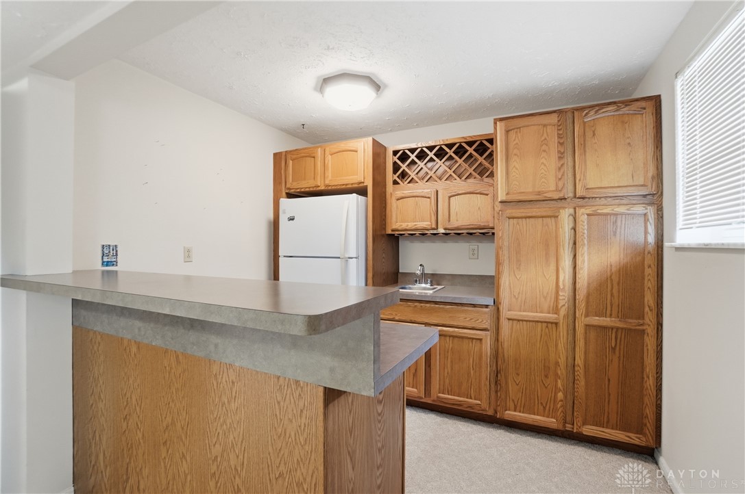 9964 Hummingbird Way Dayton, OH 45458 - Photo 43 of 57 This convenient wet bar and entertainment area offers ample storage and a built-in wine rack.