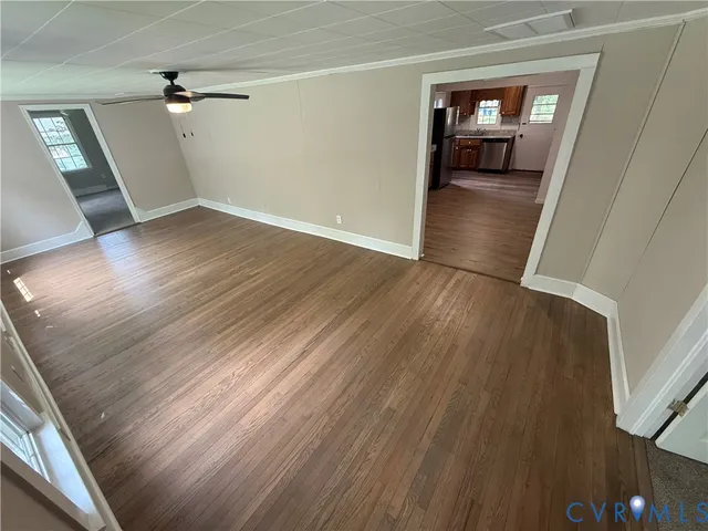 wooden floor in an empty room with a window