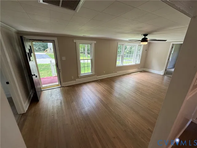 wooden floor in an empty room with a window