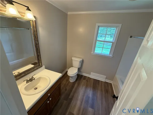 a bathroom with a sink mirror vanity and toilet