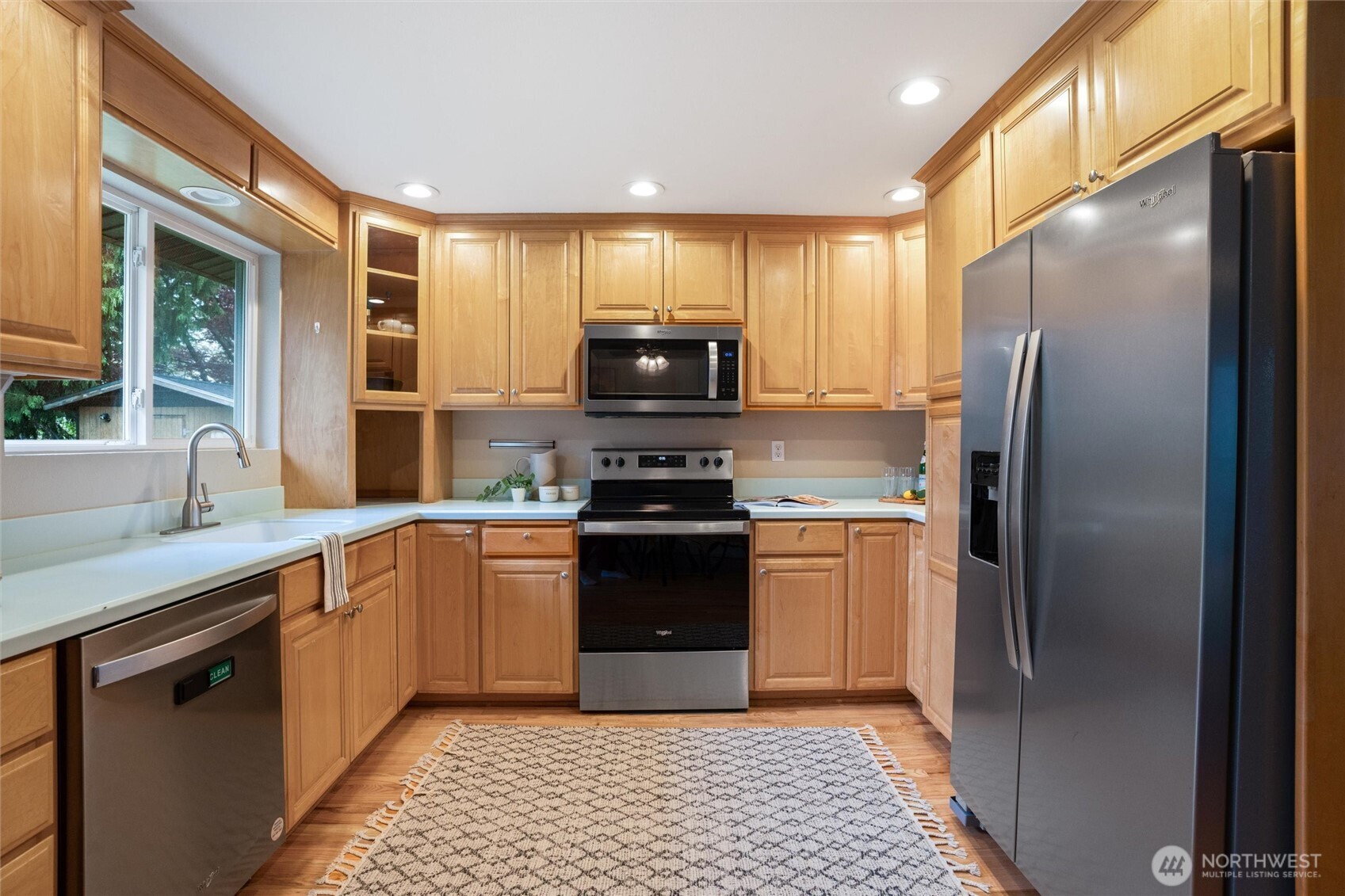3876 Northeast Pinecone Drive Bremerton, WA 98310 - Photo 11 of 27 a kitchen with granite countertop a refrigerator and a sink