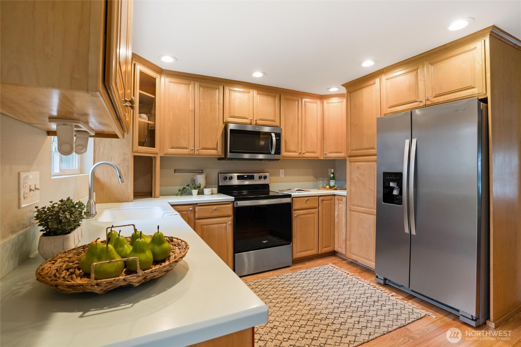 3876 Northeast Pinecone Drive Bremerton, WA 98310 - Photo 13 of 27 a kitchen with stainless steel appliances granite countertop a refrigerator a stove a sink and a microwave