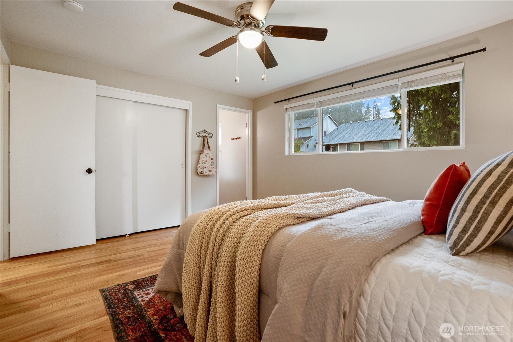 3876 Northeast Pinecone Drive Bremerton, WA 98310 - Photo 20 of 27 a bedroom with a bed and a painting on the wall